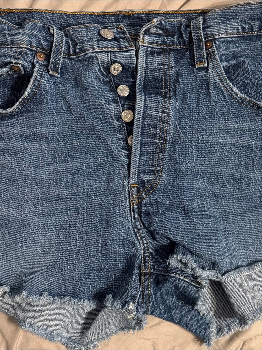Levi's tan leather patch with faded red print on denim